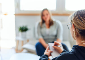 person starting cognitive-behavioral therapy in session with counselor